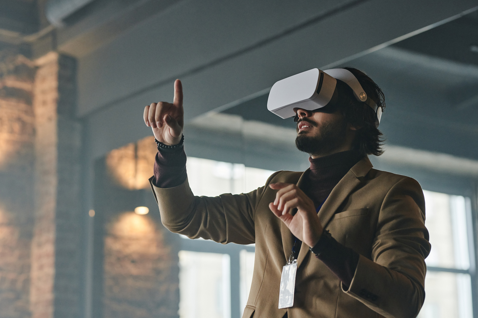 A Man in Corporate Attire Using VR Goggles